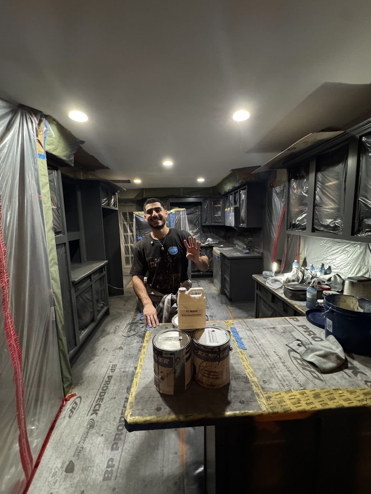 Charcoal cabinets masked for spraying Charcoal cabinet refinishing project with masking and spray preparation in place