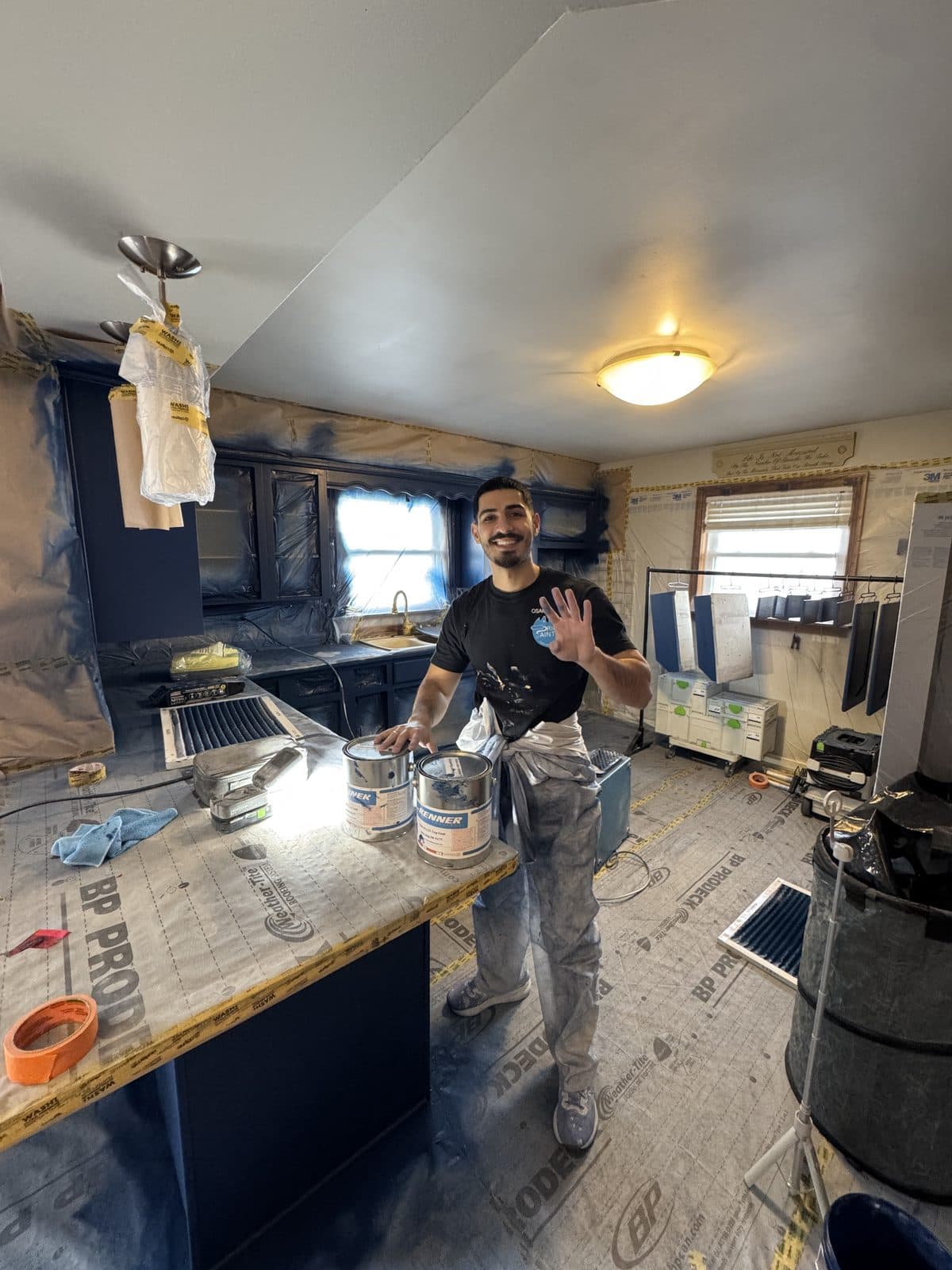 Navy cabinet spray project Navy cabinet spray project in progress with Renner paint cans and protected floors