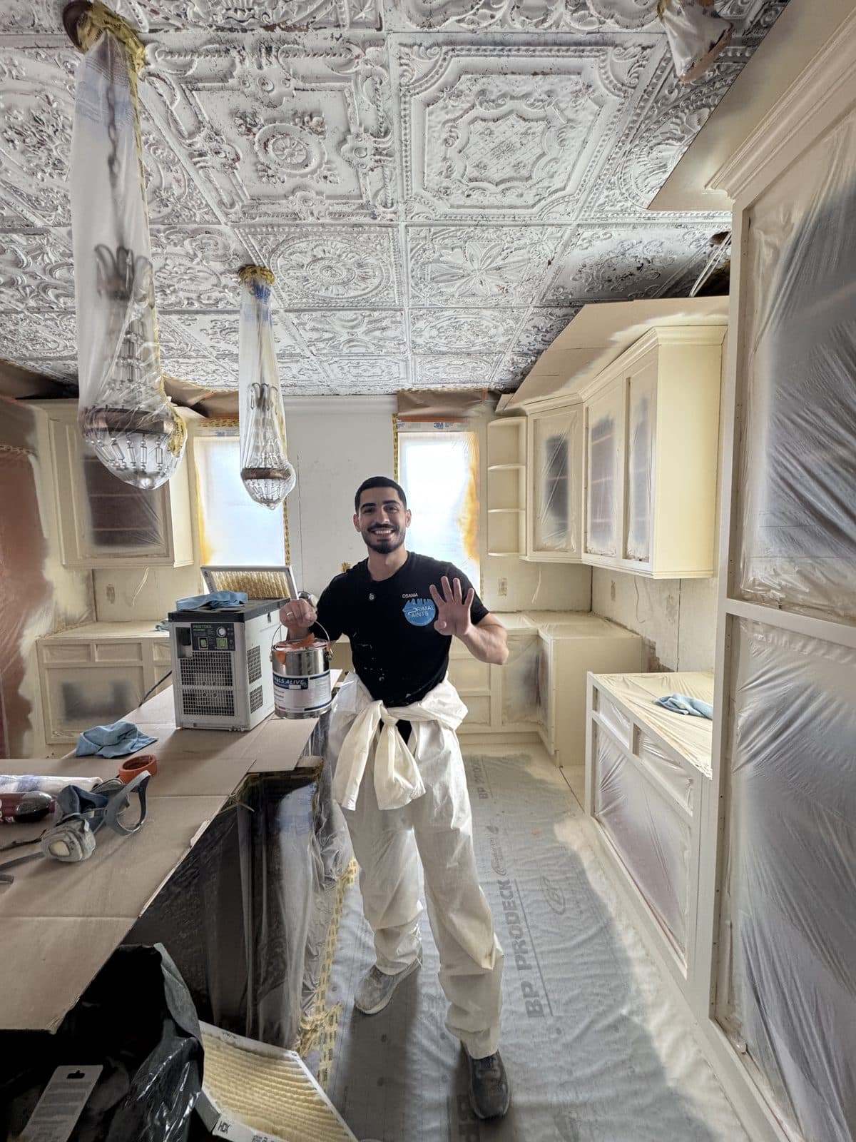 White cabinet refinish with ornate ceiling White cabinet refinishing project in a kitchen with an ornate ceiling