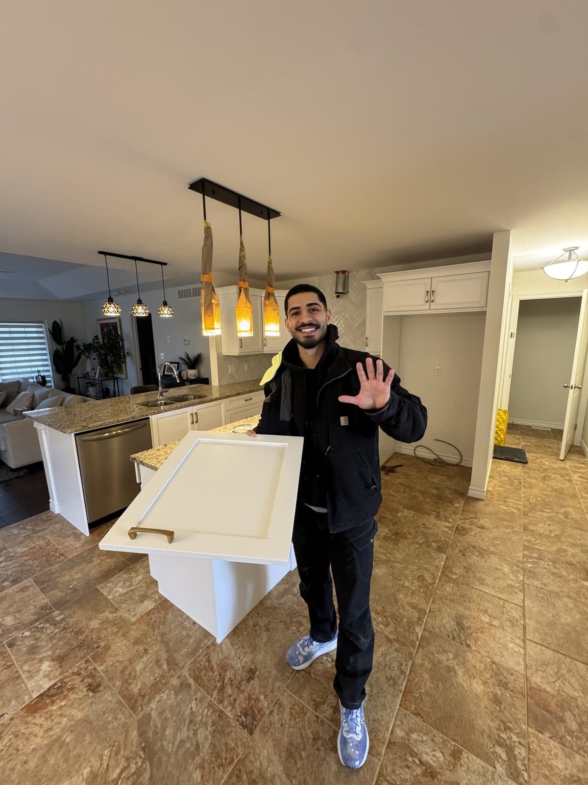 White shaker door refinish Owner holding a white shaker cabinet door during a kitchen refinishing project